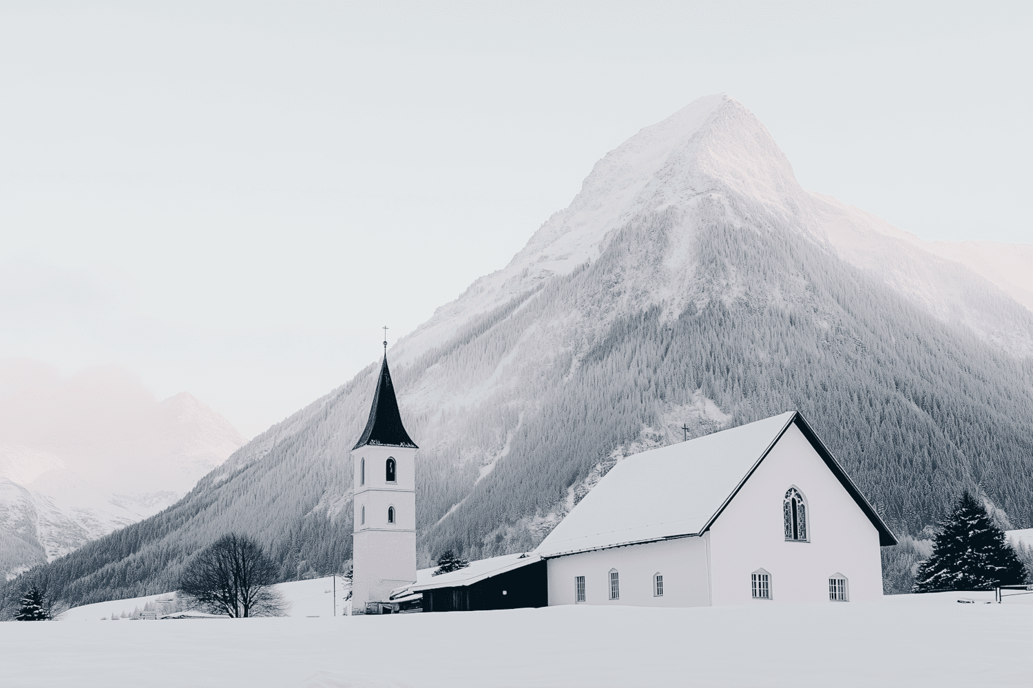 A snow covered church with a tall steeple