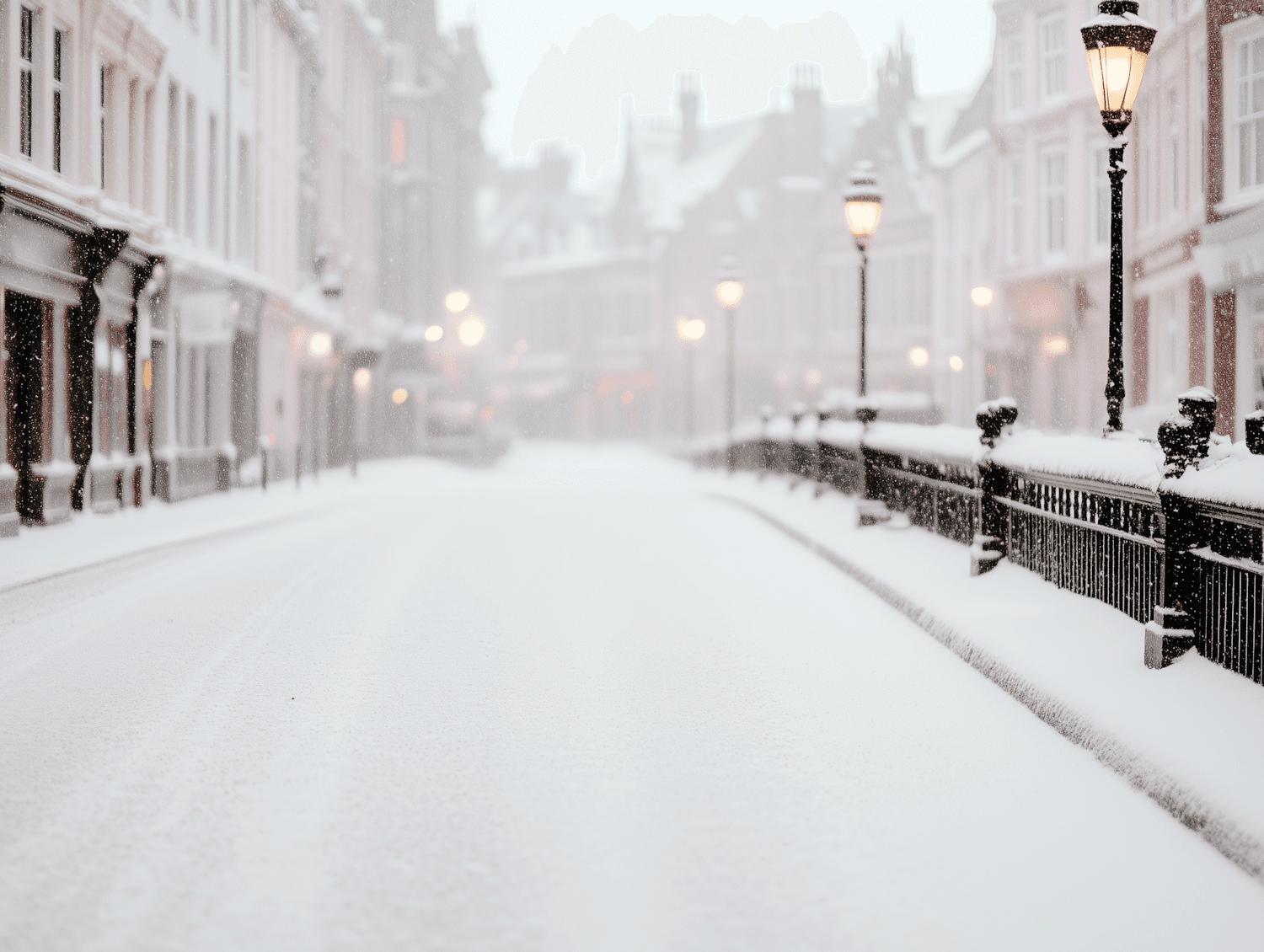 A snow covered street lit by glowing lamps